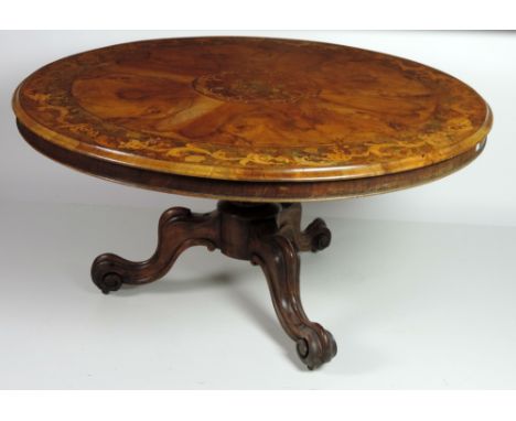 A superb Victorian burr walnut and marquetry Breakfast Table, the finely figured 136cms (4'6") top with large centre panel an