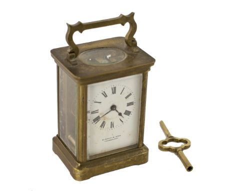 A small late 19th Century brass Carriage Clock, with French movement and enamel dial with Roman numerals, the distributors na