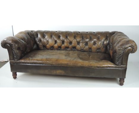 A Victorian Chesterfield Settee, with deep buttoned back and sides, covered in dark brown leather. (1)