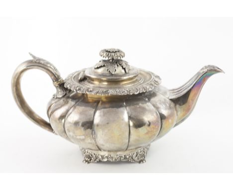 An English George IV silver melon shaped Teapot, with embossed lid, decorated rim, with silver handle, on shell decorated cir