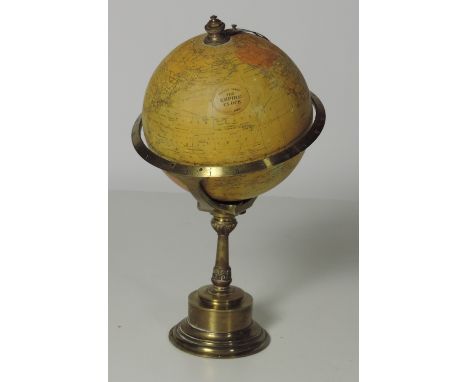 A rare and unusual early 20th Century Terrestrial clockwork Desk Globe, "The Empire Clock," Patent 19460, the chapter engrave