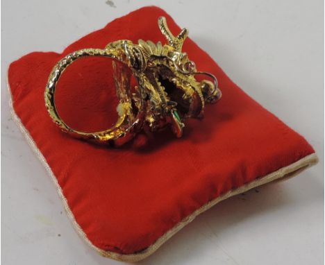 Gold: A large and unusual heavy 14ct gold Gents Ring, elaborately modelled as a dragons head, with small inset ruby eyes, and