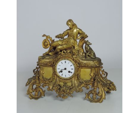 A large 19th Century French ormolu Mantle Clock, with elegant figure and dog surmounted, the circular enamel dial signed T. N