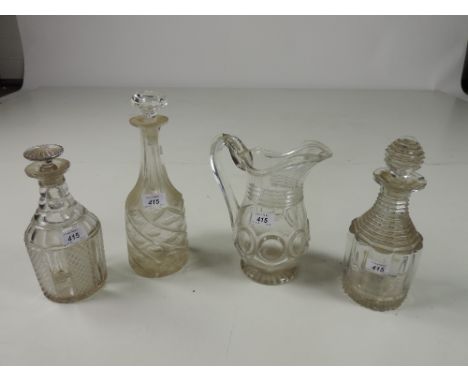 An antique cutglass triple-ring neck Decanter, and matching stopper, two other cutglass Decanters, and an antique cutglass Ju