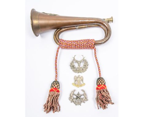A copper bugle, mounted with a cast brass badge of the Argyll &amp; Sutherland Highlanders, with coloured cords and tassels; 