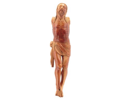 CEYLON, 17TH CENTURY, A CARVED IVORY CORPUS CHRISTI, stained a russet colour, feet pierced, arms and cross lacking, 23.5cm hi