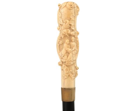 A 19TH CENTURY AND LATER WALKING CANE, the early ivory handle carved in shallow relief with a courtly couple in a garden, and