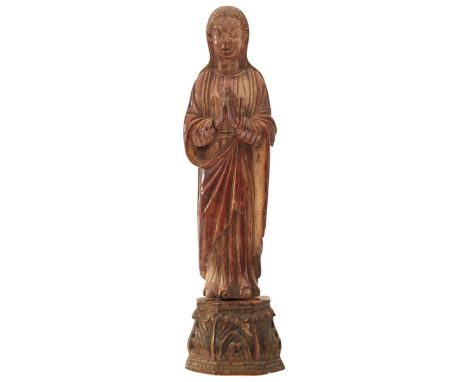 CEYLON, 17TH CENTURY, A CARVED IVORY FIGURE OF THE MADONNA IMMACULATE, her hands clasped in prayer, russett stained, on assoc