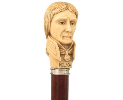 AN EARLY 20TH CENTURY WAKING CANE, the ivory handle carved as the bust of Nelson, tapering wooden haft, metal ferrule, 92cm l