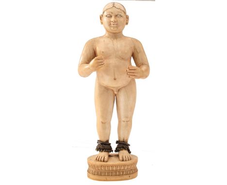 GOA, 19TH CENTURY, A CARVED IVORY FIGURE OF A MAN, possibly a deity, standing naked, his forearms raised, metal pierced ears 