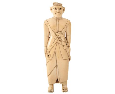 CEYLON, EARLY 19TH CENTURY, A CARVED IVORY FIGURE WEARING A KASTANE, 18cm high. From an established West Country Collection.