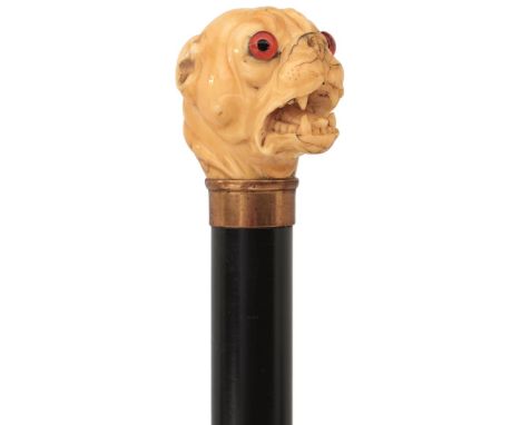 AN 18TH CENTURY AND LATER WALKING CANE, the early ivory handle carved as the head of a bulldog with later glass eyes, later e