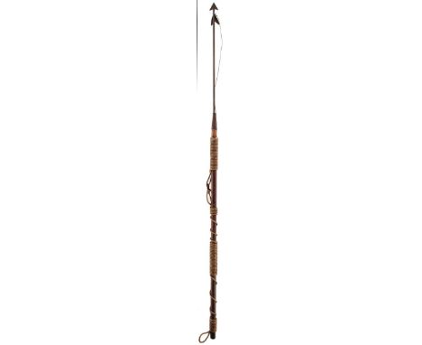 A WHALING HARPOON, steel head and haft with traces of red paint, on long wooden lower haft with rope bindings, 174cm long ove