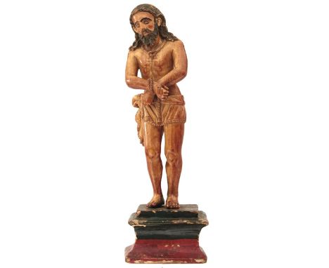 GOA, 17TH CENTURY, A CARVED IVORY FIGURE OF CHRIST AS ECCE HOMO, standing - his hands tied, with russett and black staining, 