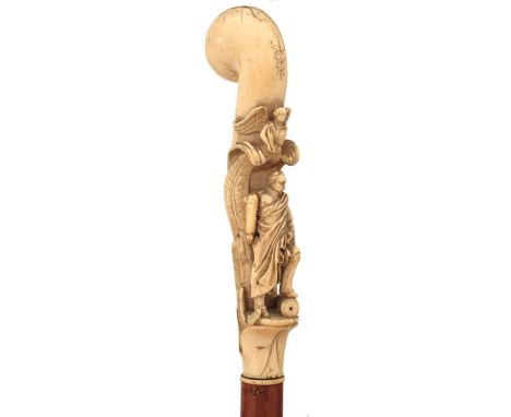 A 19TH CENTURY WALKING CANE, the ivory pistol grip handle carved in relief with a cloaked General his foot resting on a morta