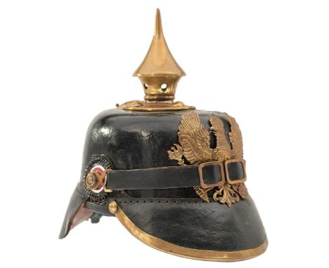 A GOOD MODEL DESK ORNAMENT OF A PRUSSIAN PICKELHAUBE, the leather skull applied with regulation brass mounts and Imperial coc