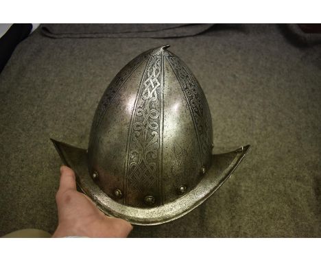 AN ITALIAN ETCHED MORION-CABASSET IN THE PISAN STYLE, the skull of characteristic almond form with down swept shallow brim dr