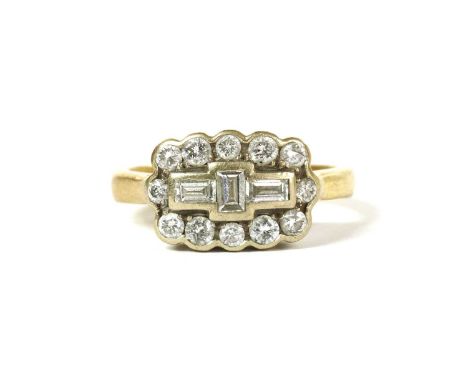 A gold diamond cluster ring, with three baguette cut diamonds in portrait and landscape orientation, rub set to the centre, t