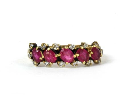 A gold ruby and diamond ring, with a row of oval mixed cut rubies and outer rows of brilliant cut diamonds, all claw set, to 