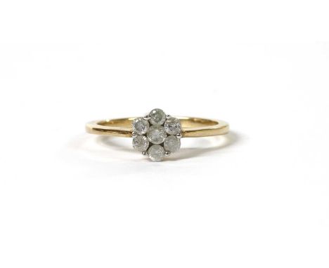 A gold diamond daisy cluster ring, with seven brilliant cut diamonds, with a stated total weight of 0.50ct, all set to tapere