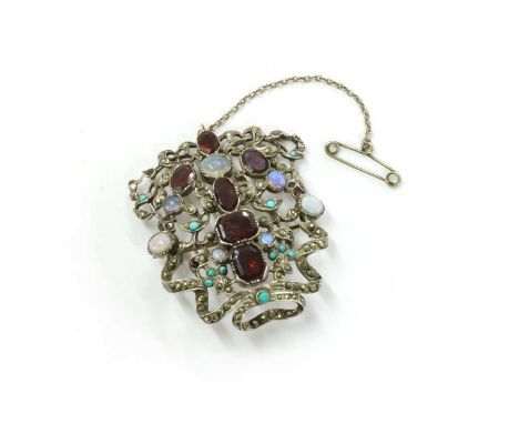 A silver assorted gemstone plaque, later converted to a brooch, with flat cut garnets, cabochon opals, cabochon turquoise and