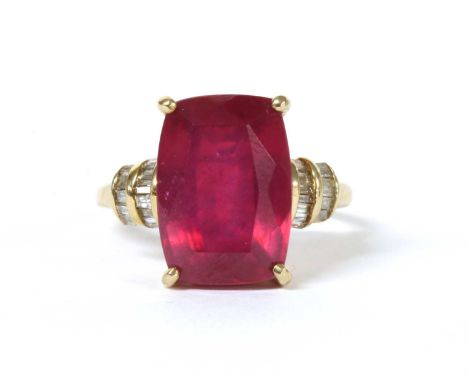 A gold fracture filled ruby and diamond ring, a cushion cut fracture filled ruby, approximately 14 x 10mm, claw set, with two