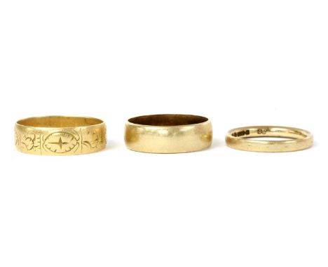 Three gold wedding rings, to include an 18ct gold flat section wedding ring with hand engraved pattern, 6mm wide, London 1887