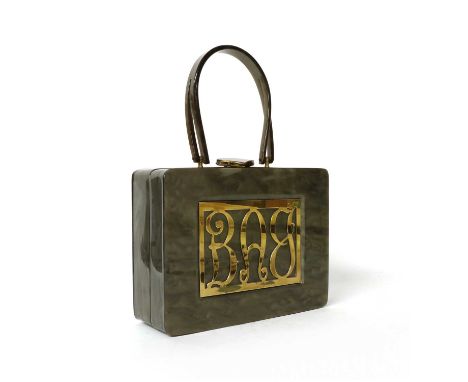 A vintage lucite handbag, by Wilardy, the front with gold tone decoration spelling 'BAG', the top with single flat handle and