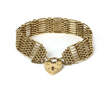A 9ct gold seven row gate bracelet, with heart shaped padlock clasp and safety chain, Sheffield 1976, 23.77gCondition report: