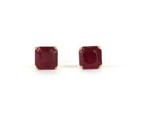 A pair of gold single stone fracture filled ruby stud earrings, with an octagonal mixed cut fracture filled ruby, approximate