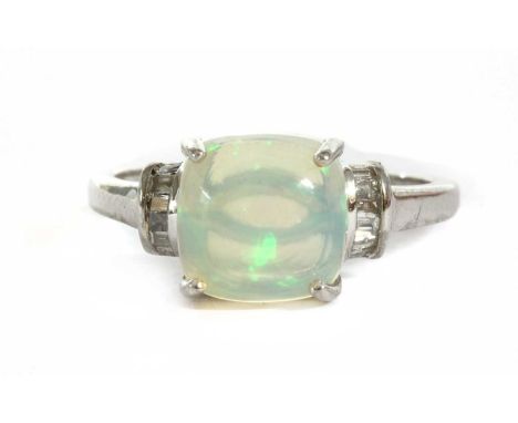 A white gold opal and diamond ring, a cushion shaped cabochon opal, approximately 9mm, claw set, to shoulders channel set wit