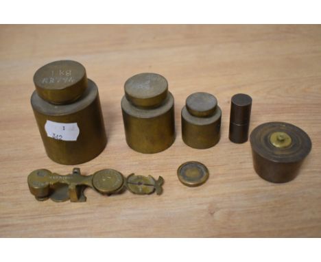 Three vintage cylindrical brass graduated weights, 1kg to 200g, plus other weights, and a set of brass sovereign scales