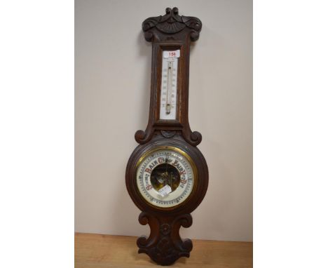 A Victorian wall hanging oak barometer with thermometer.
