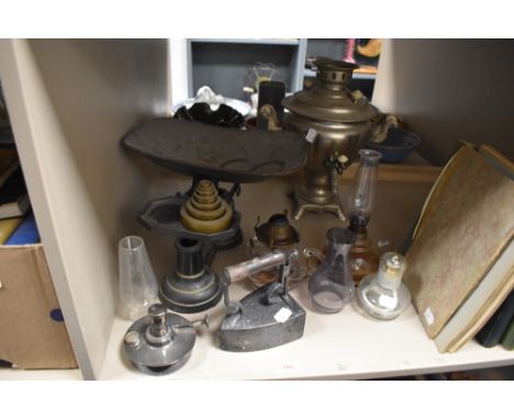 A mixed lot of vintage brass weighing scales, samovar, flat iron and various oil lamp parts.