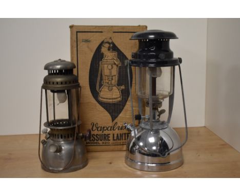 A vintage chrome metal Vapalux Pressure Lantern with box and another storm lantern, the largest measures 40cm tall