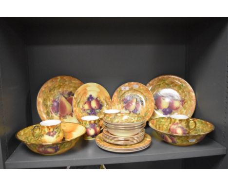 A quantity of Staffordshire porcelain tableware, in the style of Royal Worcester, decorated with a fruit design