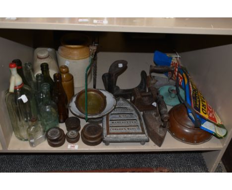 A selection of vintage glass and stone bottles, an enamel candlestick, weights, stone hot water bottle etc.