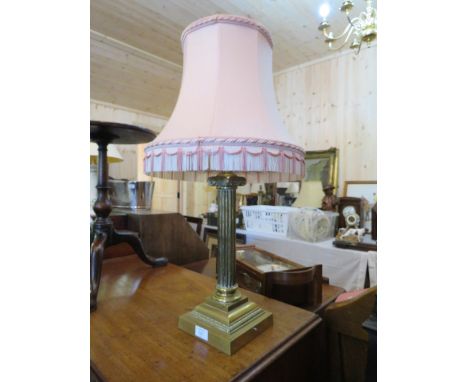 A LARGE AND HEAVY BRASS CORINTHIAN COLUMN TABLE LAMP AND SHADE