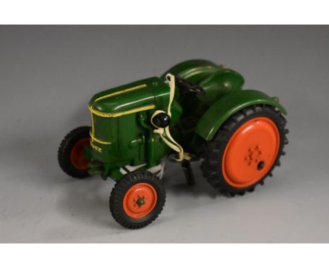 A German clockwork model of a Deutz tractor,cast green plastic body, red wheels, moulded black tyres, cast makers marks, with