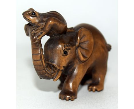 Carved hardwood netsuke in the shape of an elephant signed to the base