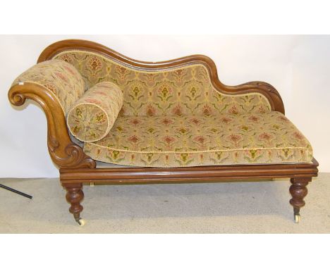 Mahogany frame small proportion chaise lounge on porcelain castors and with a round cushion support