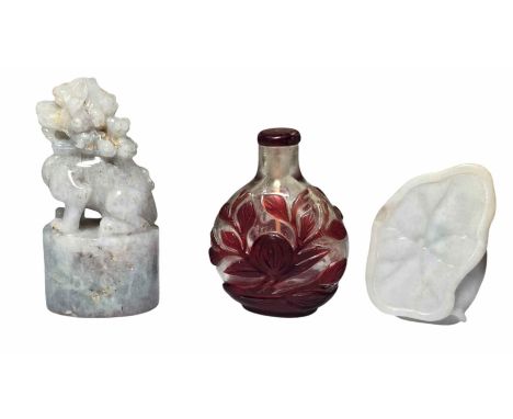 A Jade snuff bottle carved with lotus flower and leaf. A Jade guardian lion seal carved to the base. A Peking glass snuff bot