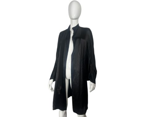 A 1920s black satin duster coat with seamed kimono sleeves and tie neck plus a collection of textiles including and Indian ta