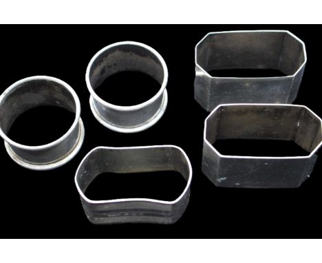 A collection of five silver napkin rings to include; a pair of George VI octagonal shaped examples, hallmarked Birmingham, 19