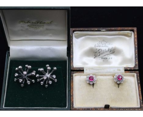 A pair of early 20th century synthetic ruby and diamond set cluster earrings, comprising a central round mixed cut stone with