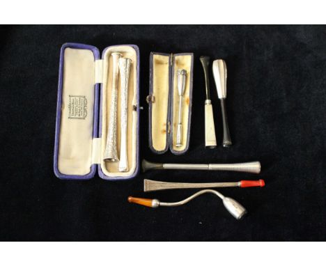 A pair of engraved sterling silver cheroot/cigarette holders, three silver engine turned examples and two white metal example