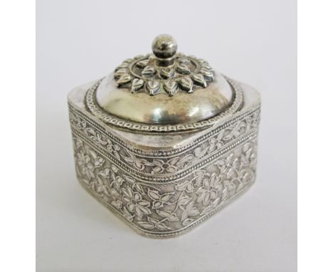 A Mughal sterling silver box with lid. Engraved with foliage to the sides and having a domed lid with petal decoration and sp