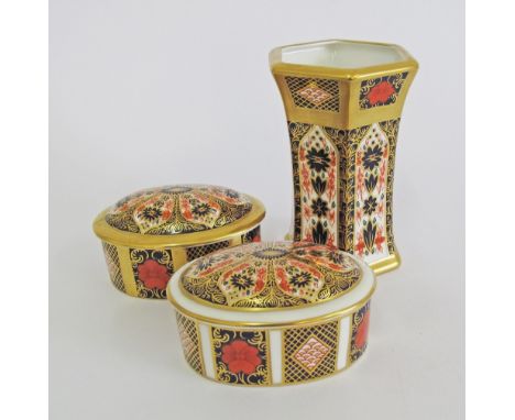 A group of English Royal Crown Derby porcelain, Old Imari pattern, comprising one fluted vase and two oval boxes and covers. 