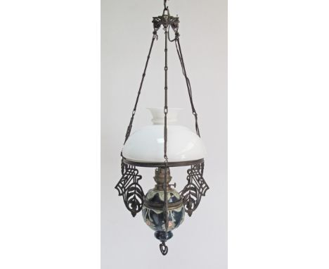 An Austrian Art Nouveau DITMAR hanging cast iron rise and fall oil lamp with a green and pinc ceramic body and original white