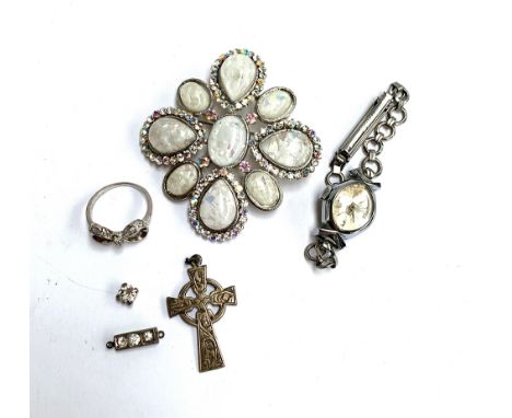 A 925 silver Celtic cross pedant; together with a 925 silver ring with bow design set with white stones; a costume brooch; a 